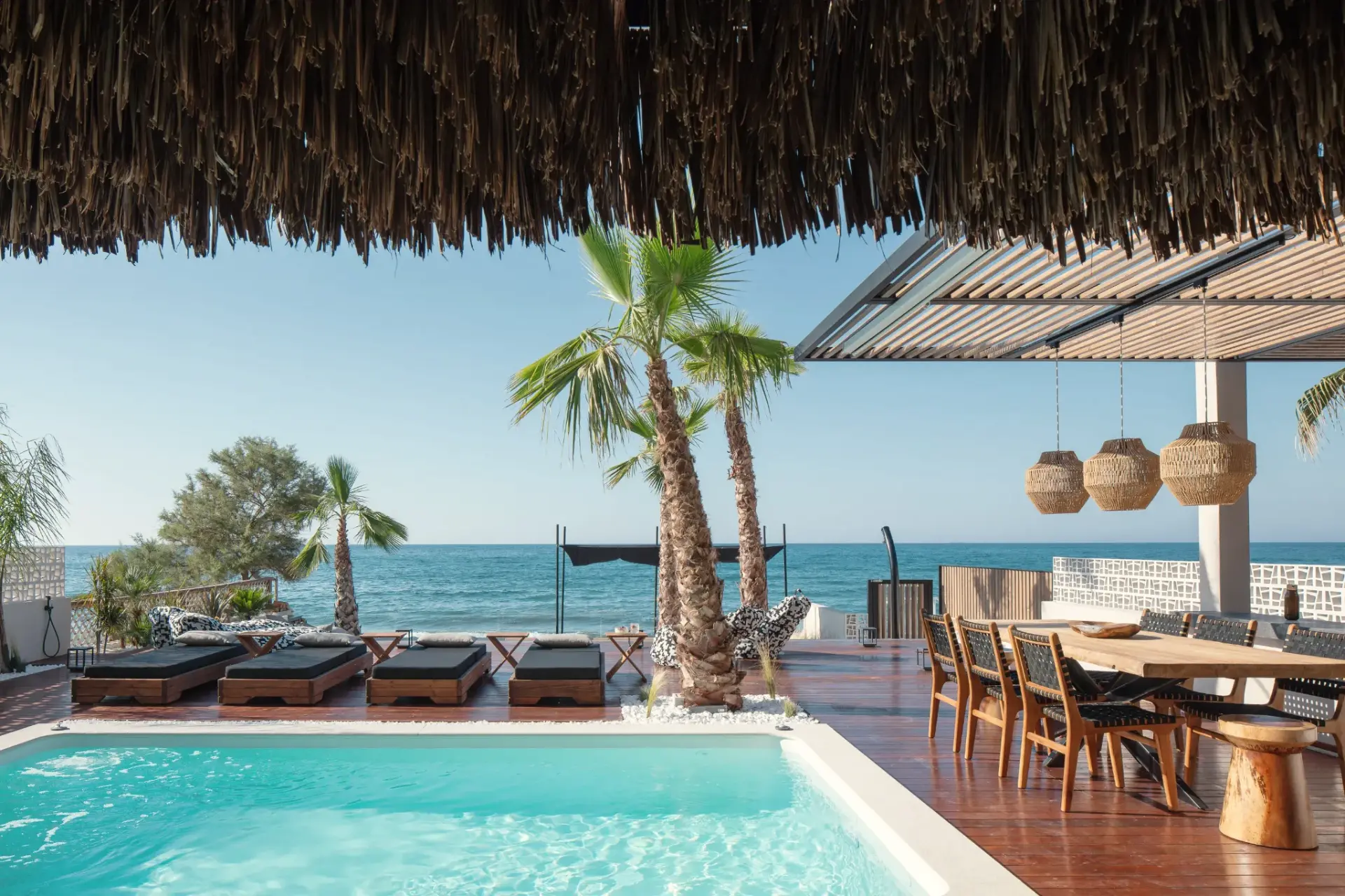 Casa Negro's pool terrace and pergola looking out over the sea in Crete